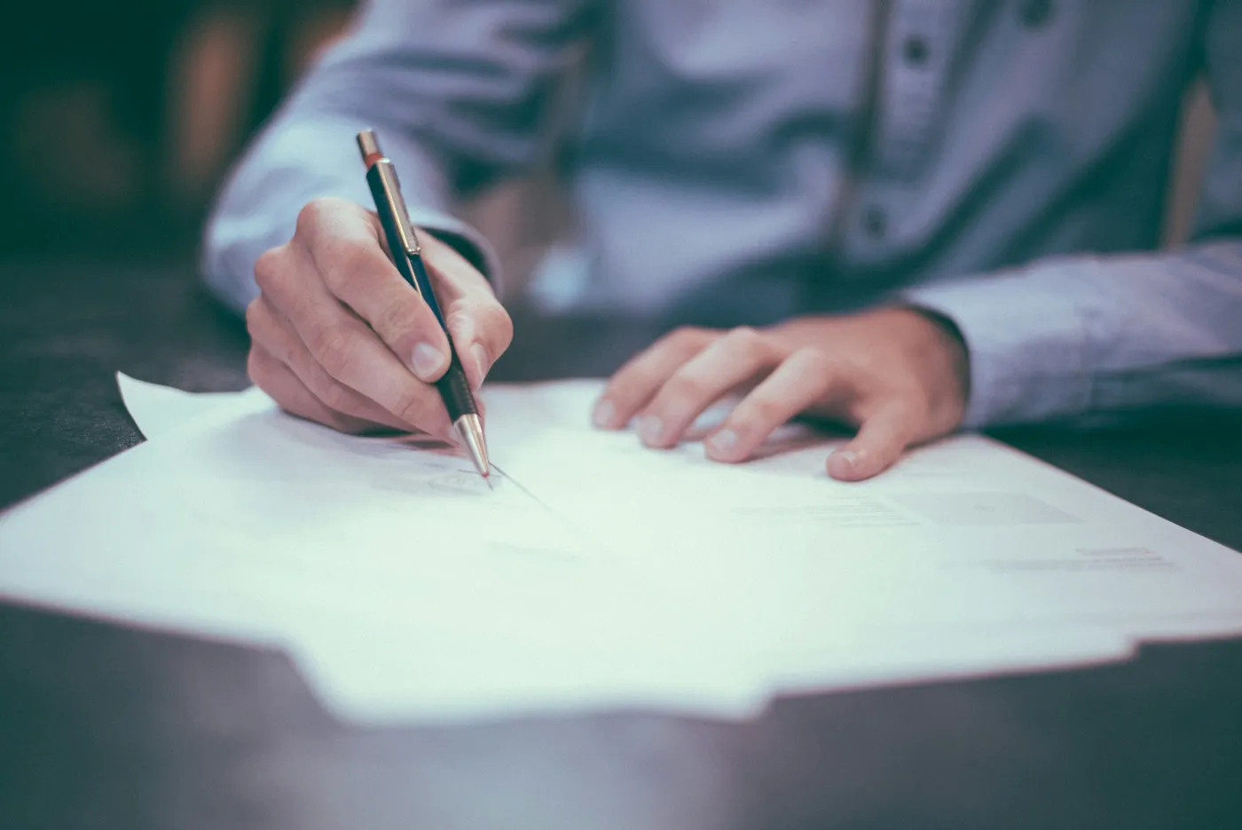 Signing a document at Clarke & Partners